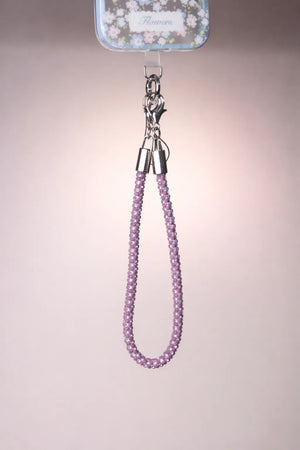 Purple beaded lanyard with a metal clip on a neutral background
